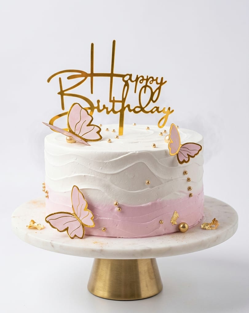 Eggless birthday cake on elegant cake stand